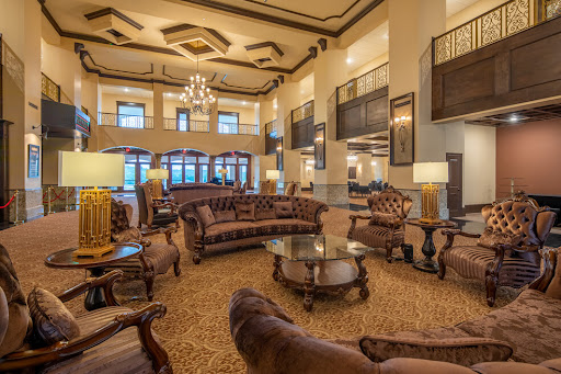A spacious and elegantly designed hotel lobby featuring luxurious furniture and ambient lighting.