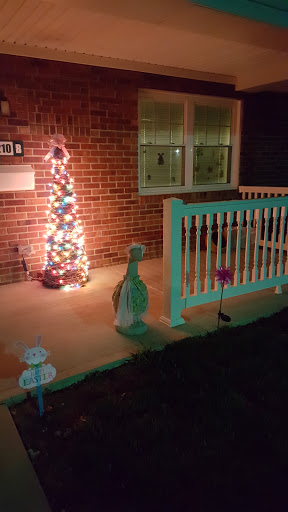 A festive front porch adorned with holiday lights and decorations.