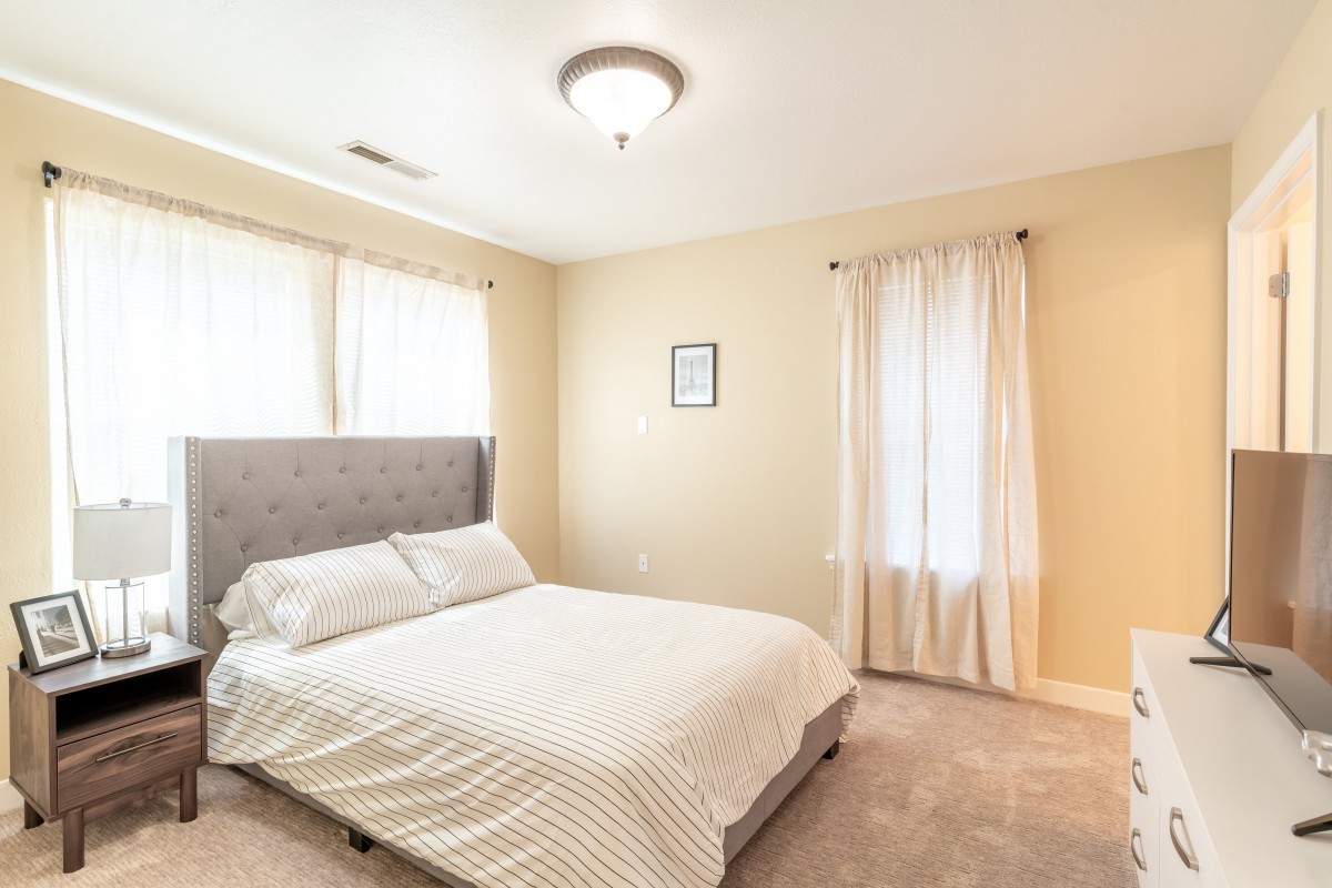 A minimalist bedroom with neutral colors and ample natural light.