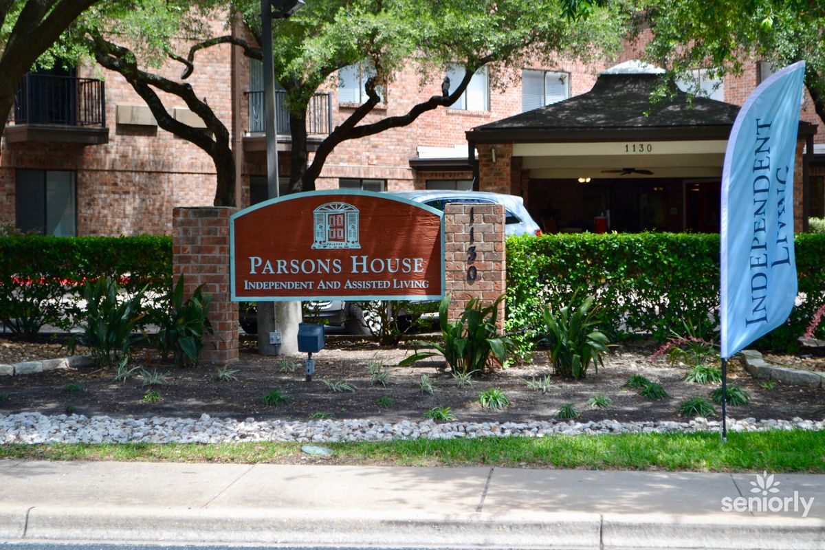 Entrance sign for Pearson House surrounded by trees and hedges.