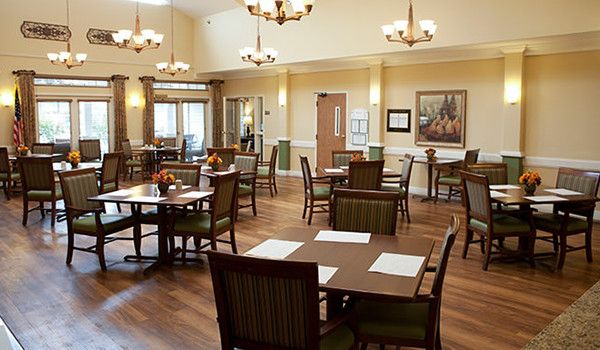 A well-lit dining area with tables and chairs arranged in a spacious setting.