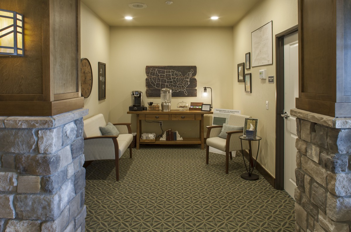 A cozy waiting room with seating and a coffee station.