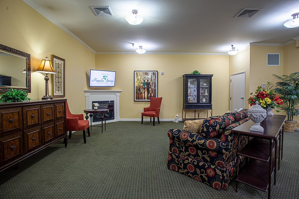 A cozy living room with various seating options, a fireplace, and decorative elements.