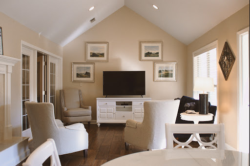 A stylish and comfortable living room featuring a modern television setup and elegant seating arrangements.