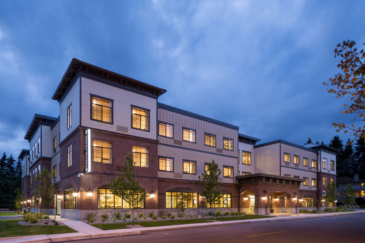 A modern building illuminated in the evening.