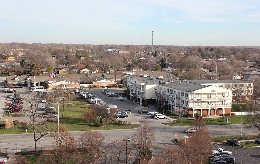 Aerial view of a suburban area with buildings and a parking lot.