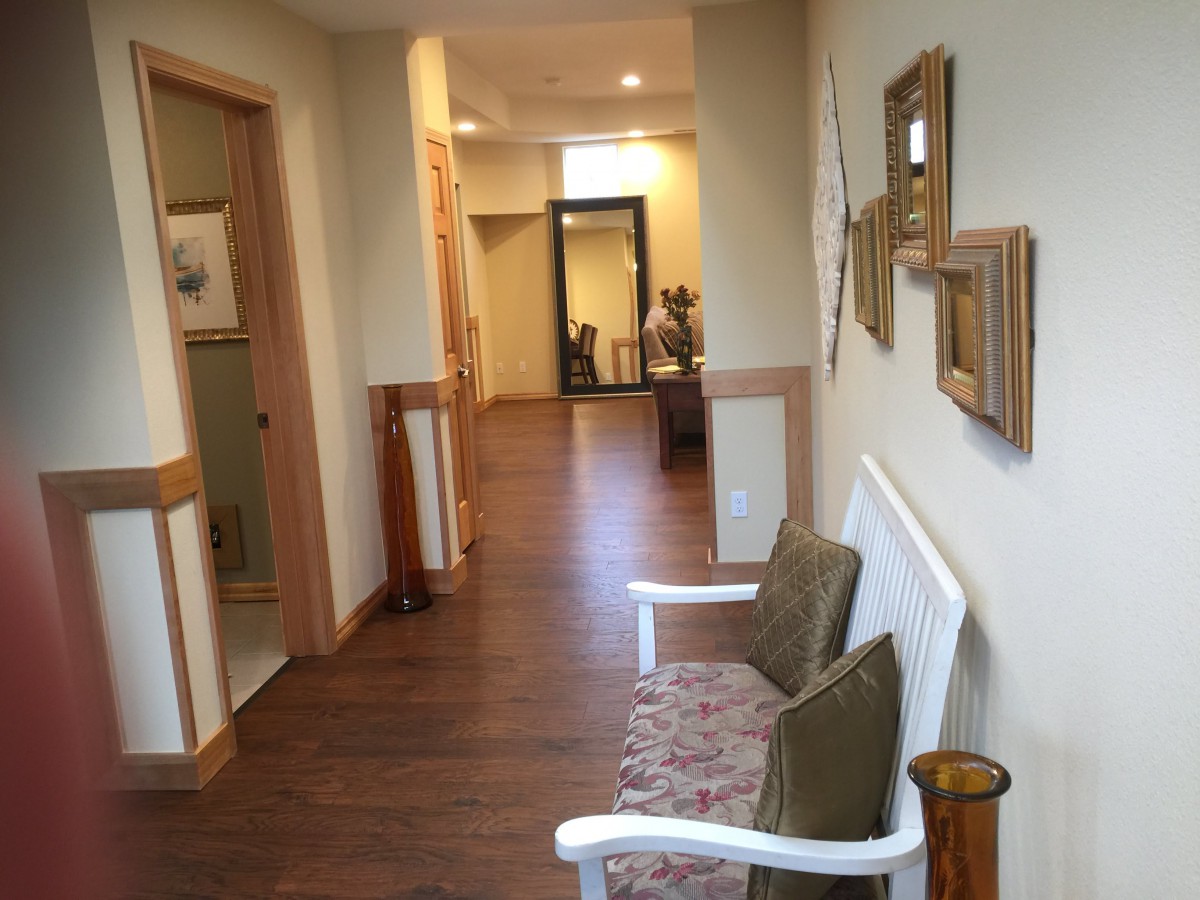 A cozy hallway with seating and wall decor.