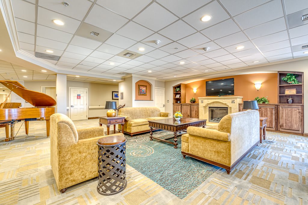 A modern lobby with comfortable seating and a fireplace.