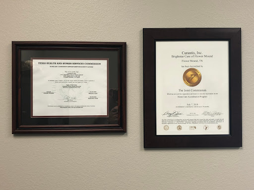 A display of framed certificates showcasing professional qualifications.
