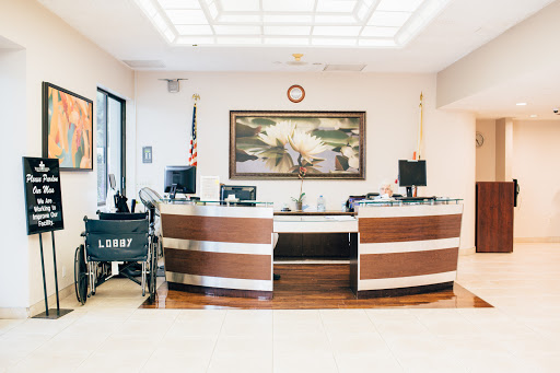 A modern reception area featuring elegant furniture and a decorative artwork.