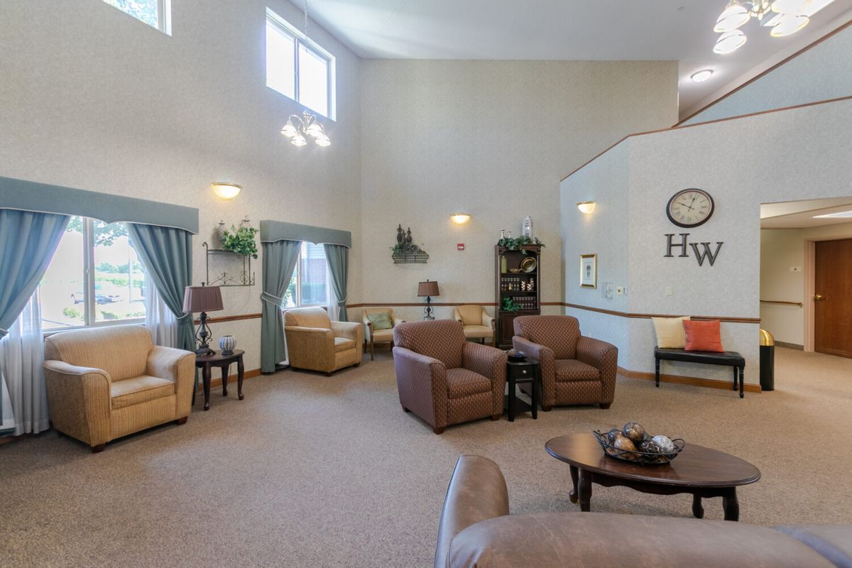A spacious and well-lit living room featuring comfortable seating and elegant decor.