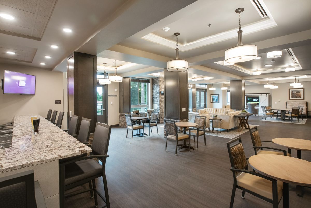 A modern dining area featuring ample seating and stylish lighting.