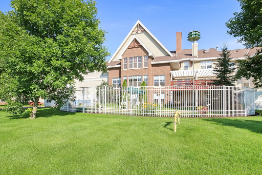 A beautiful sunny day showcasing a spacious backyard with a well-maintained lawn and a charming house.
