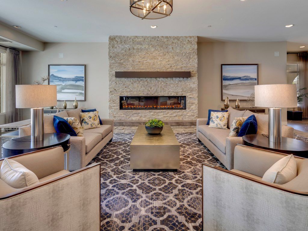 A modern living room with a central fireplace and comfortable seating arrangement.