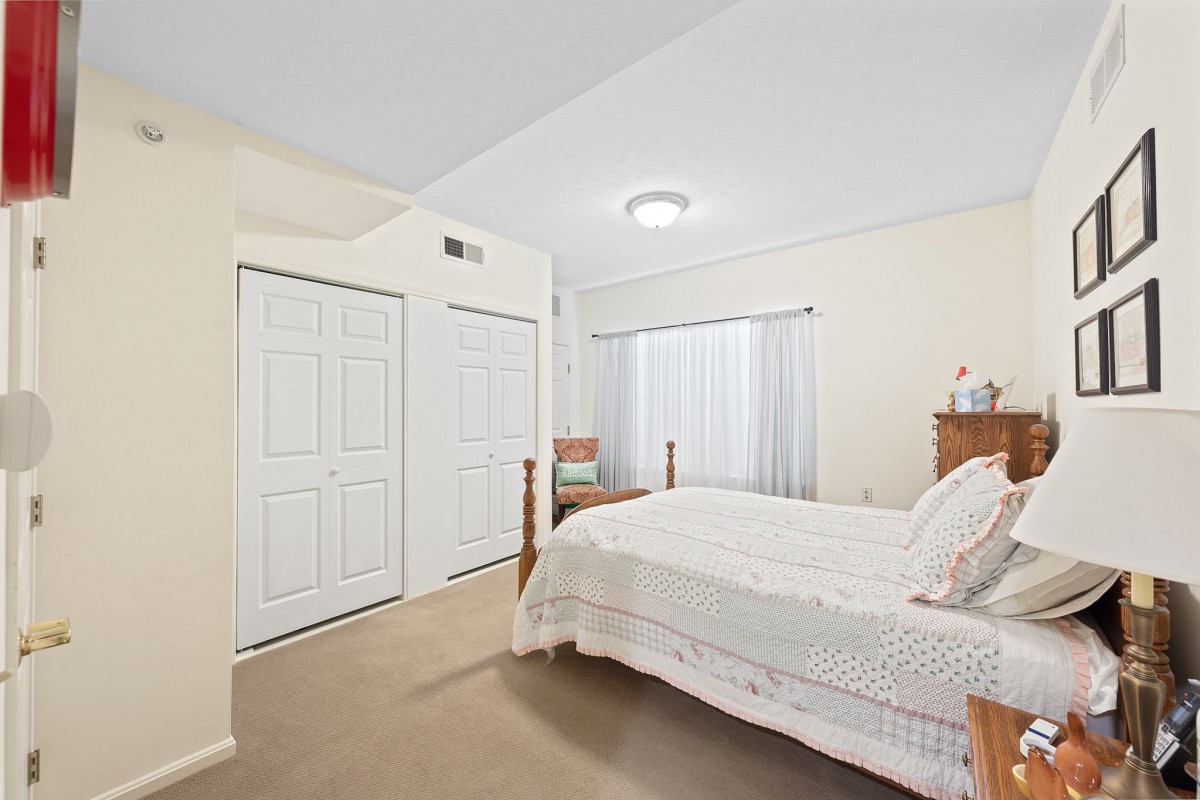 A cozy bedroom with a double bed, closet space, and a minimalist design.