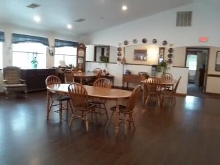 A cozy dining room with wooden tables and chairs.