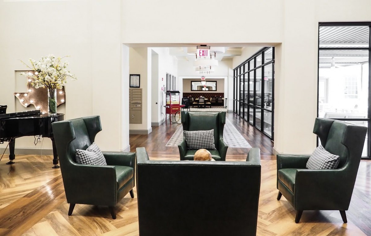 A modern and spacious living room with elegant furniture and a cozy seating area.