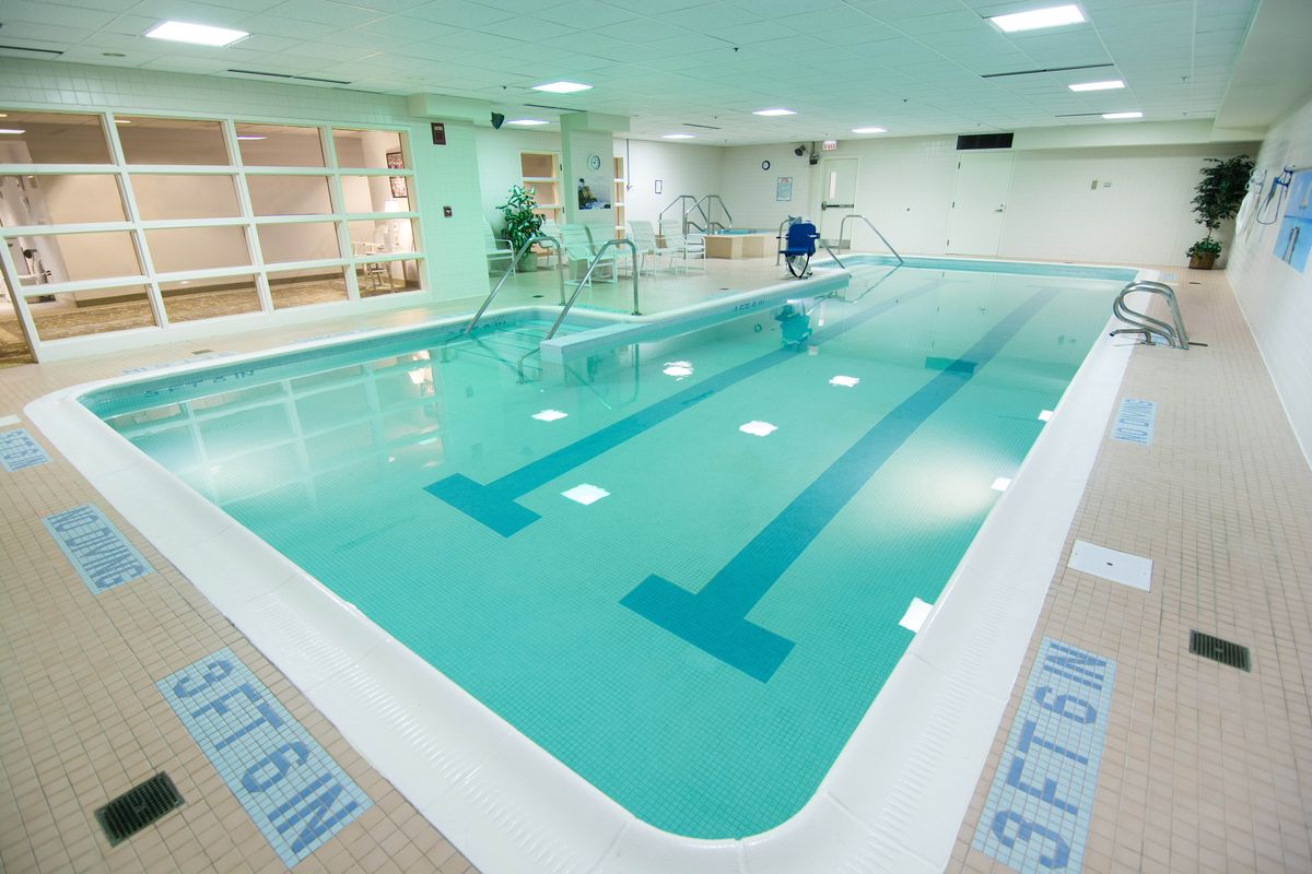 An indoor swimming pool with clear water and lane markings, ideal for exercise and relaxation.