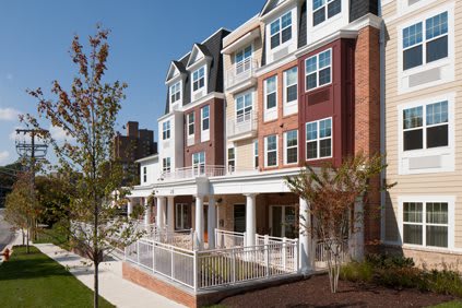 A modern residential apartment building with a diverse facade in an urban setting.