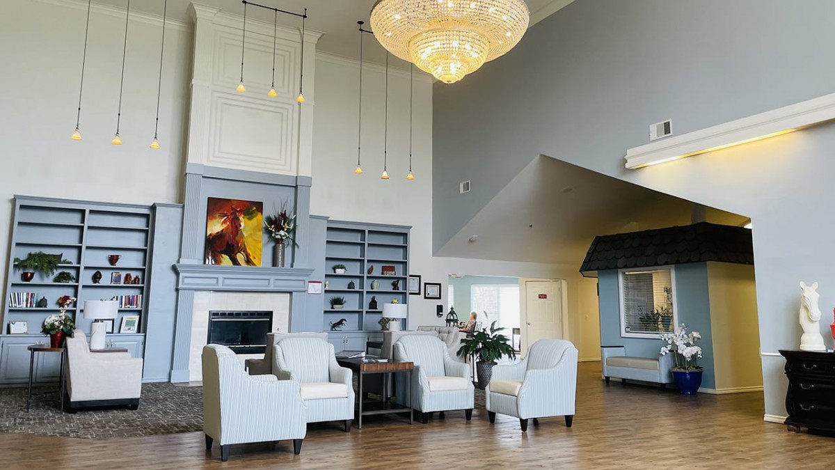 A modern lobby with stylish seating, a large chandelier, and contemporary artwork.