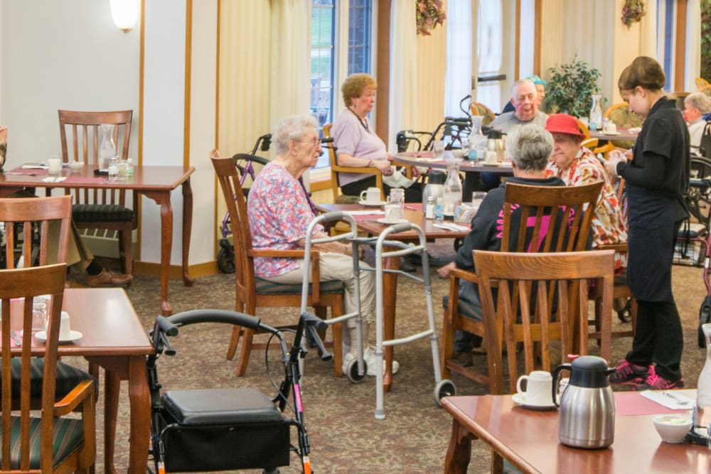 A group of elderly people dining together in a senior living community.