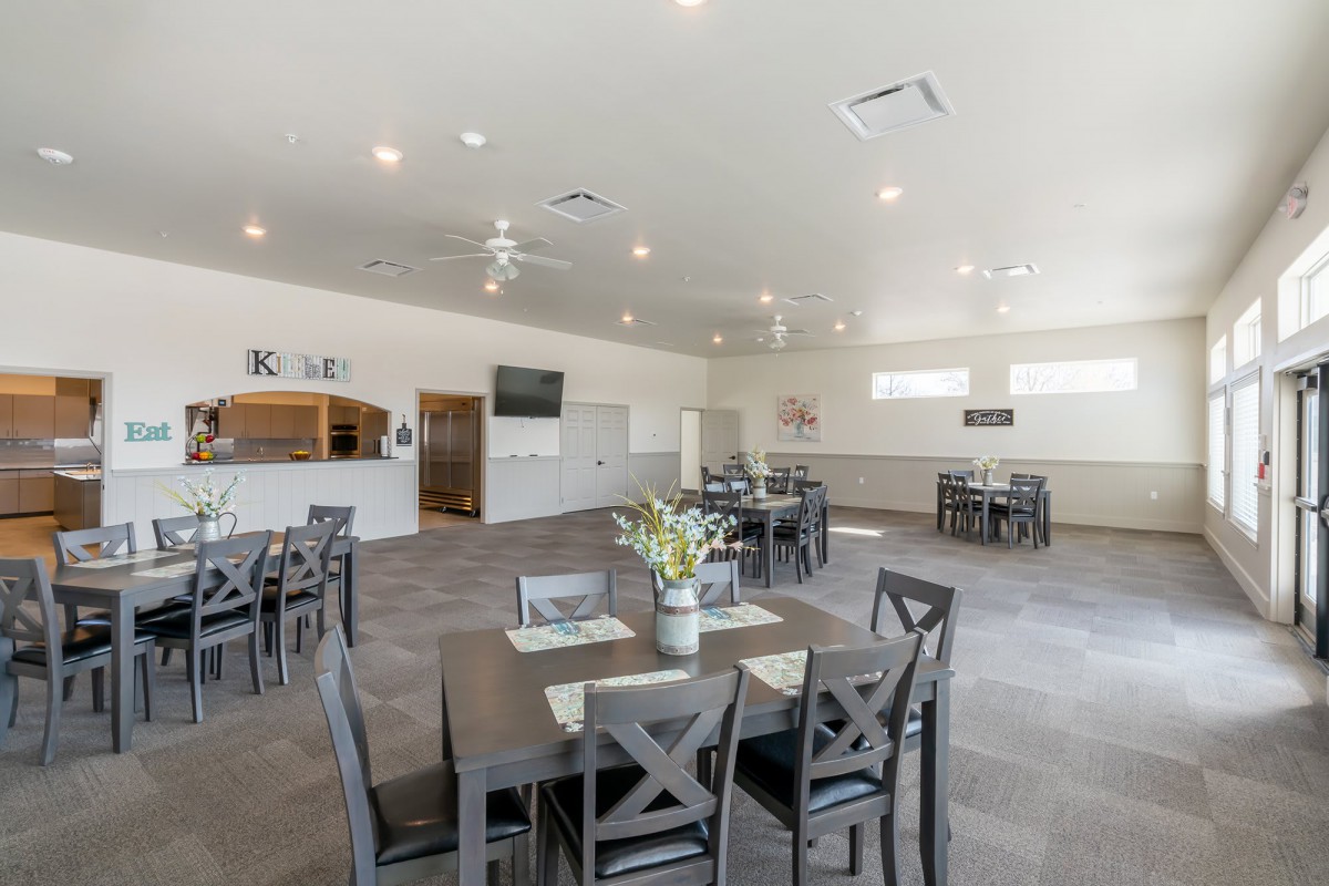 A modern and spacious dining area with multiple tables and chairs, suitable for hosting events or gatherings.