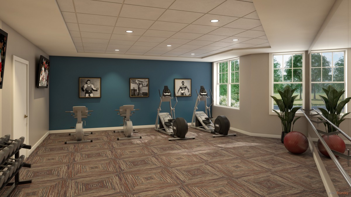 A well-lit gym with stationary bikes and framed pictures on the wall.