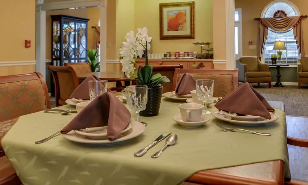 An elegantly set dining table with neatly arranged cutlery and napkins, ready for guests.