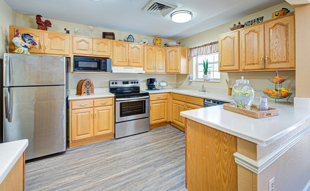 A modern kitchen with wooden cabinets and stainless steel appliances.
