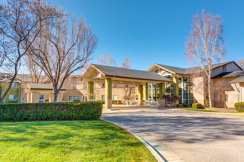 A modern building with a landscaped entrance on a sunny day.