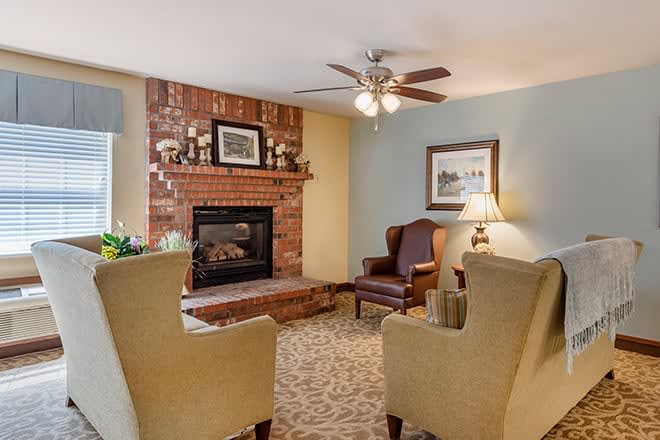A cozy living room with a brick fireplace and comfortable seating.