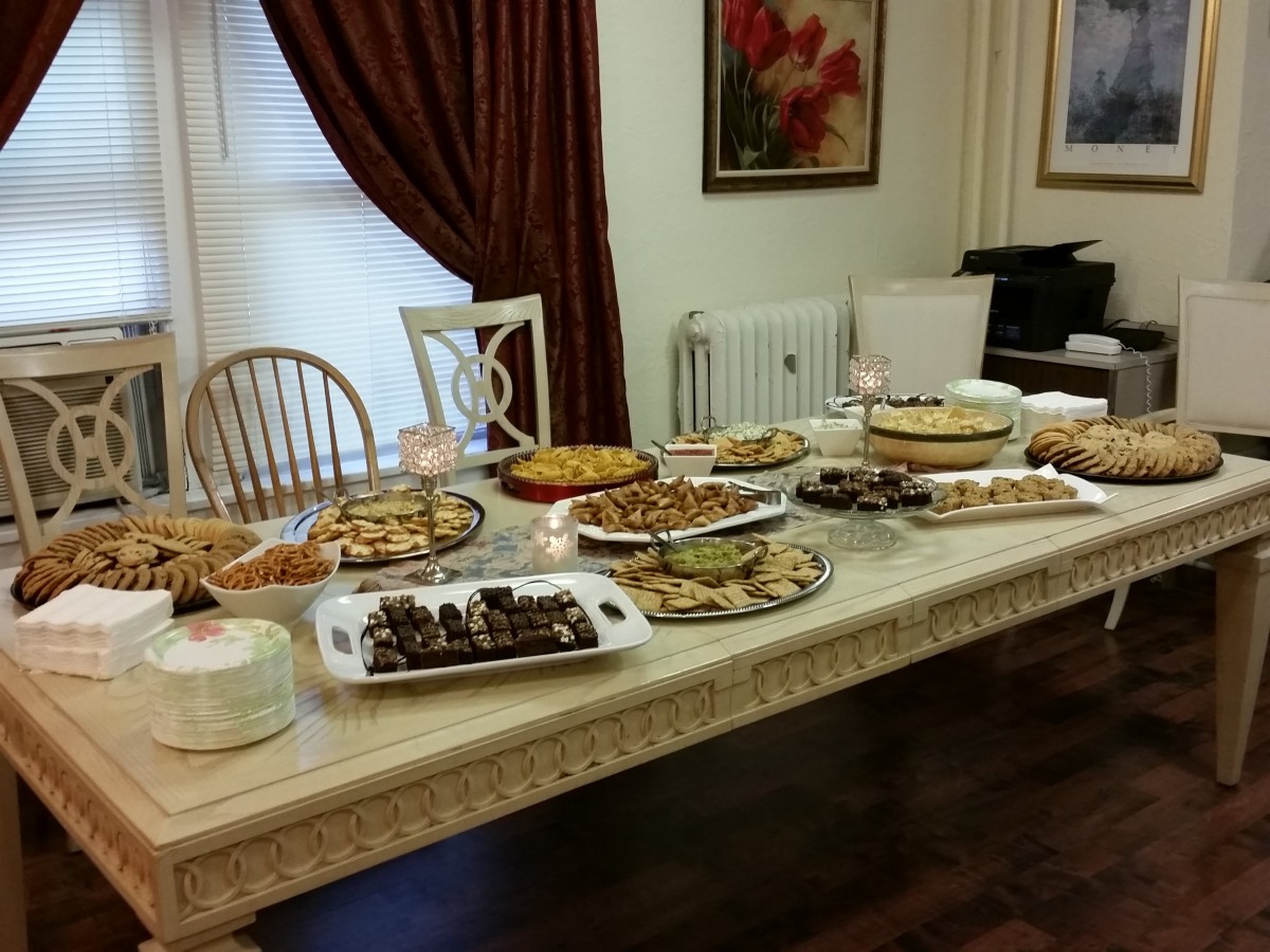 An indoor buffet table filled with a variety of desserts and pastries.