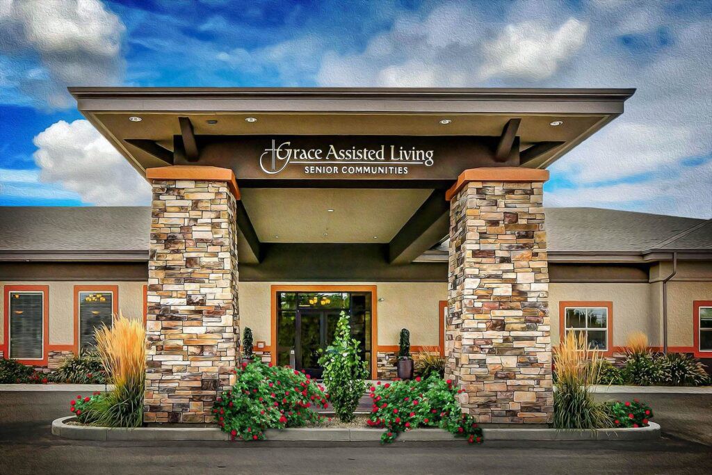 Front entrance of a modern assisted living facility with stone pillars and landscaping.