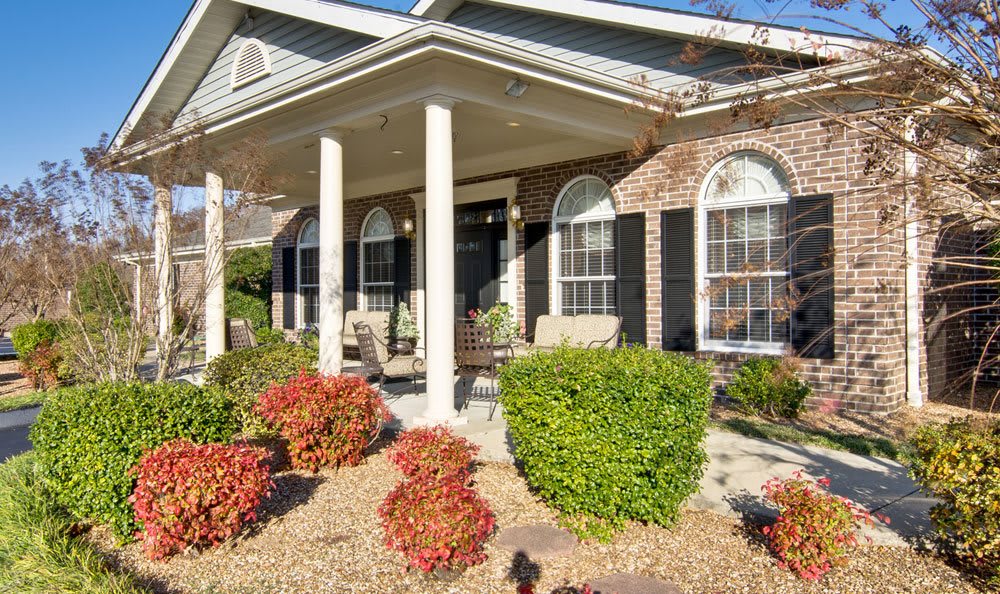 A well-maintained house with a covered porch and landscaped garden.