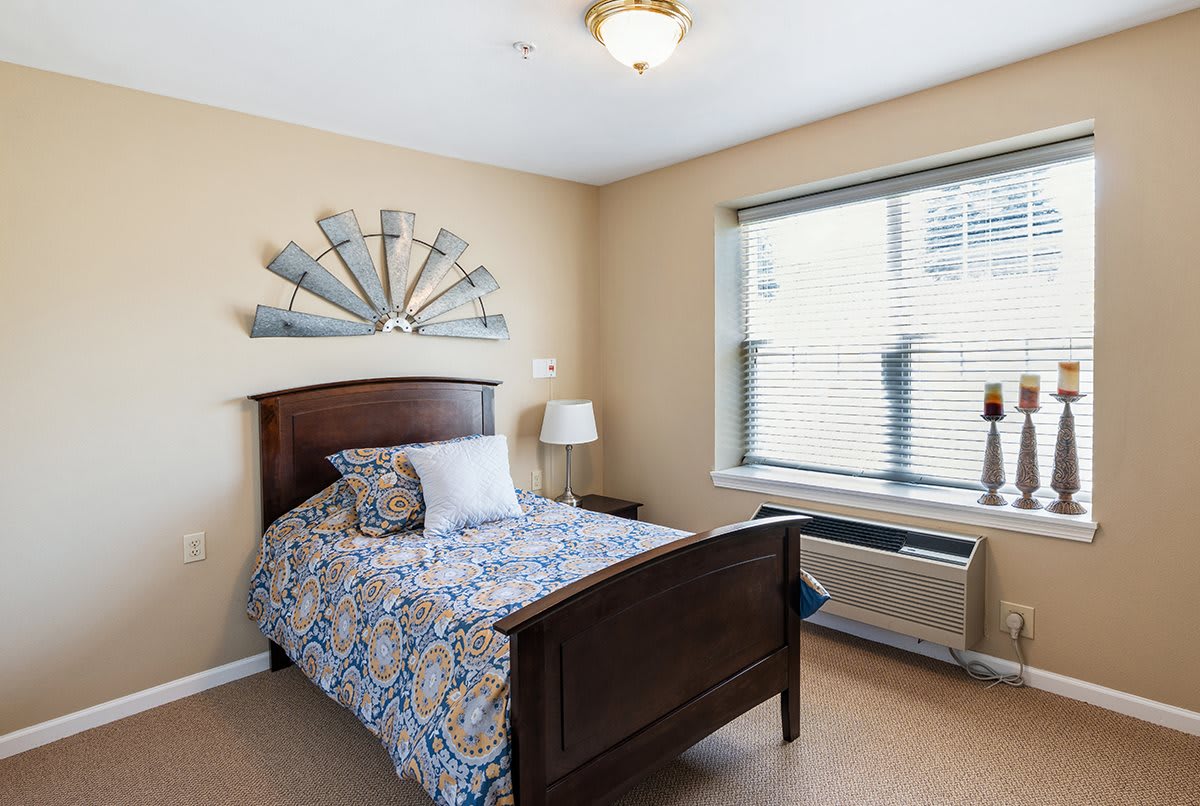 A neatly arranged bedroom with a single bed and decorative elements.