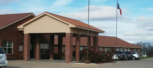 A view of the entrance to a residential building under a clear sky.