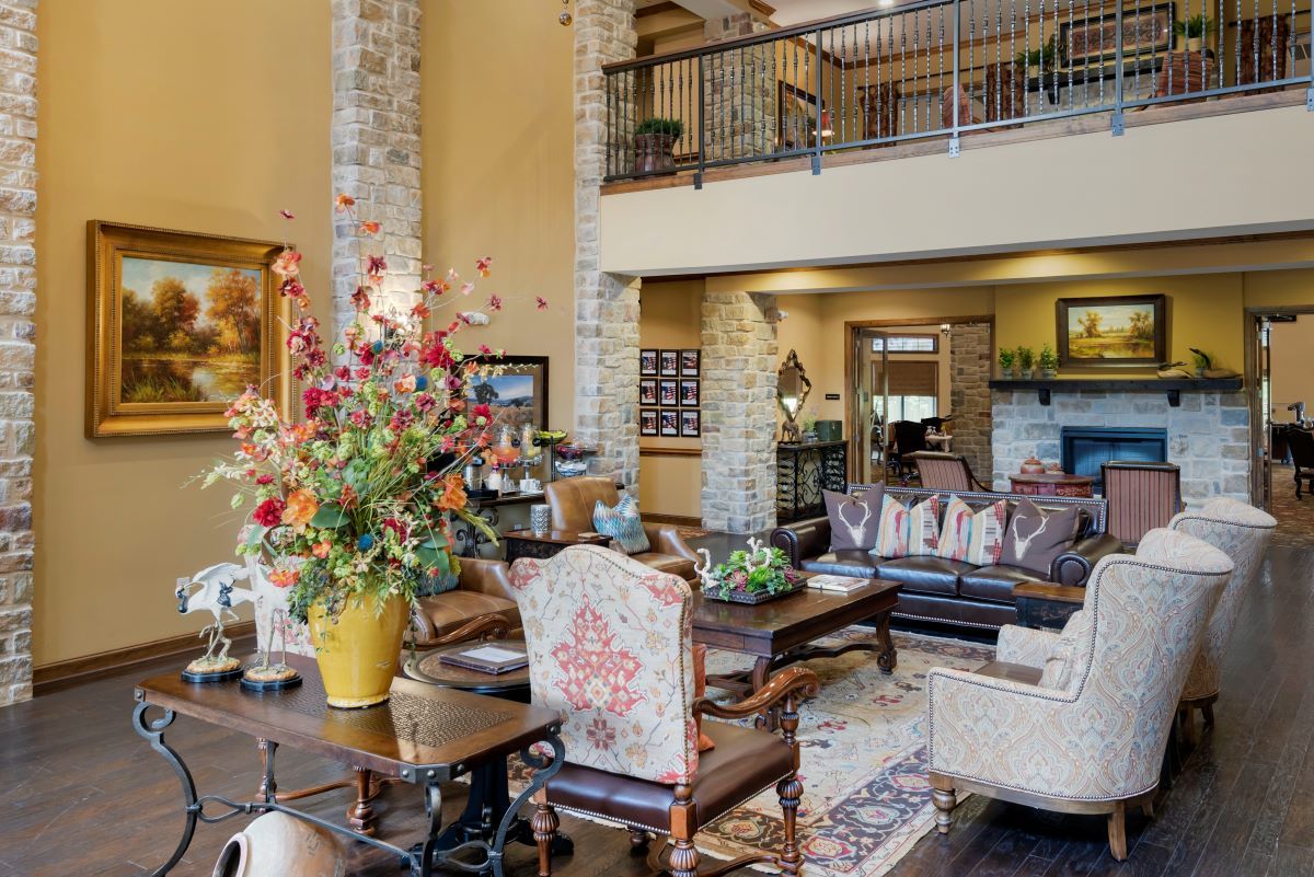 A spacious living room with a high ceiling and stylish decor, featuring comfortable seating and elegant furnishings.