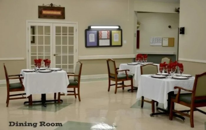 A neatly arranged dining room with tables and chairs set for guests.
