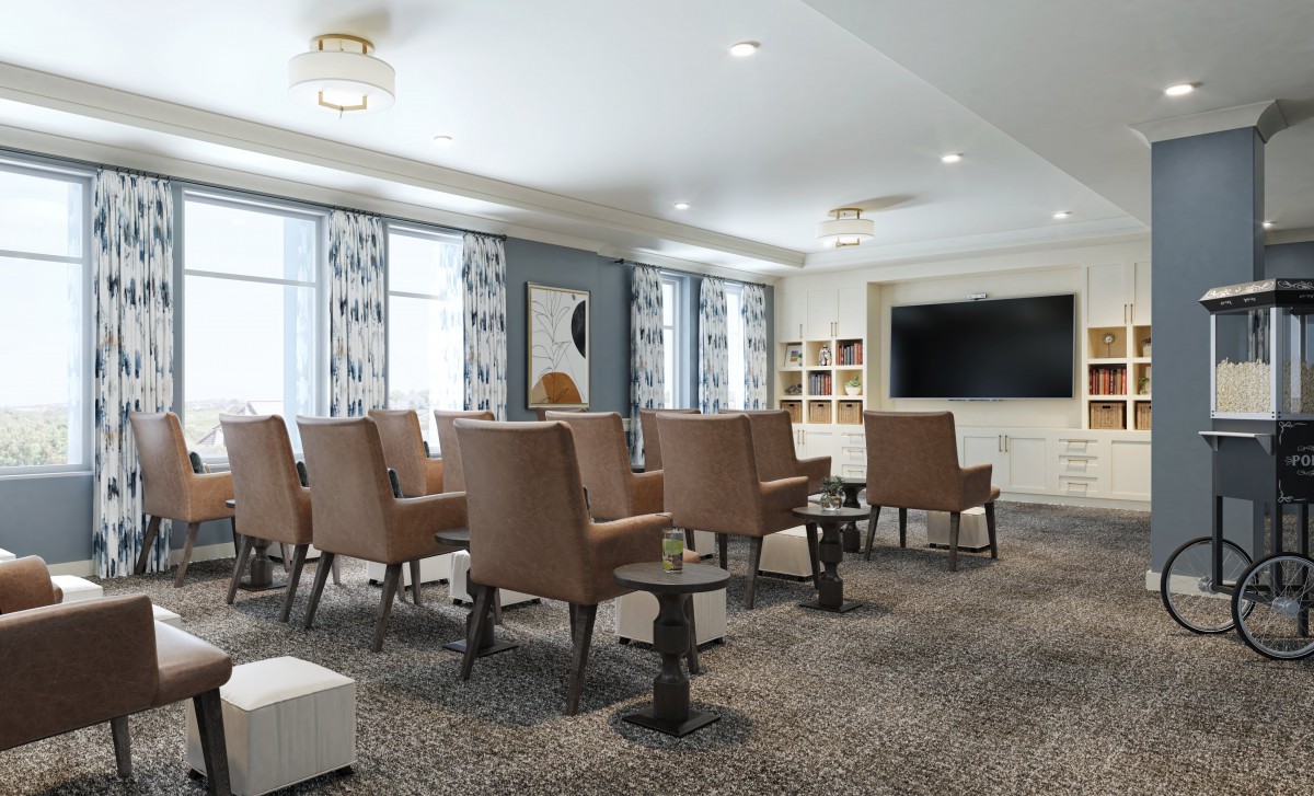 A modern conference room with comfortable seating and a large television.