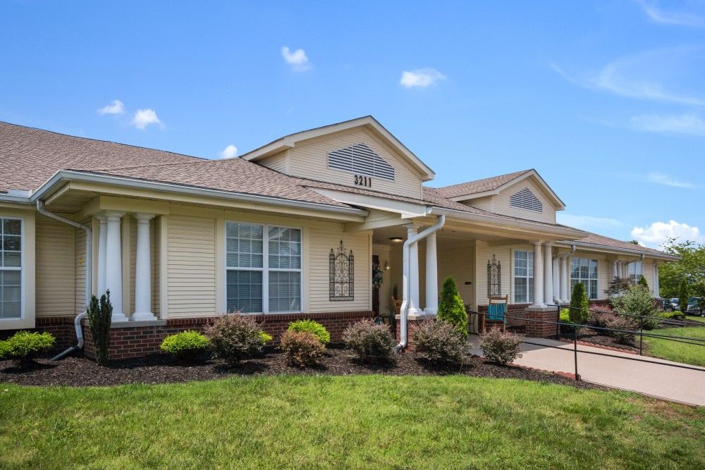 A suburban house with a well-maintained front yard and clear blue sky.