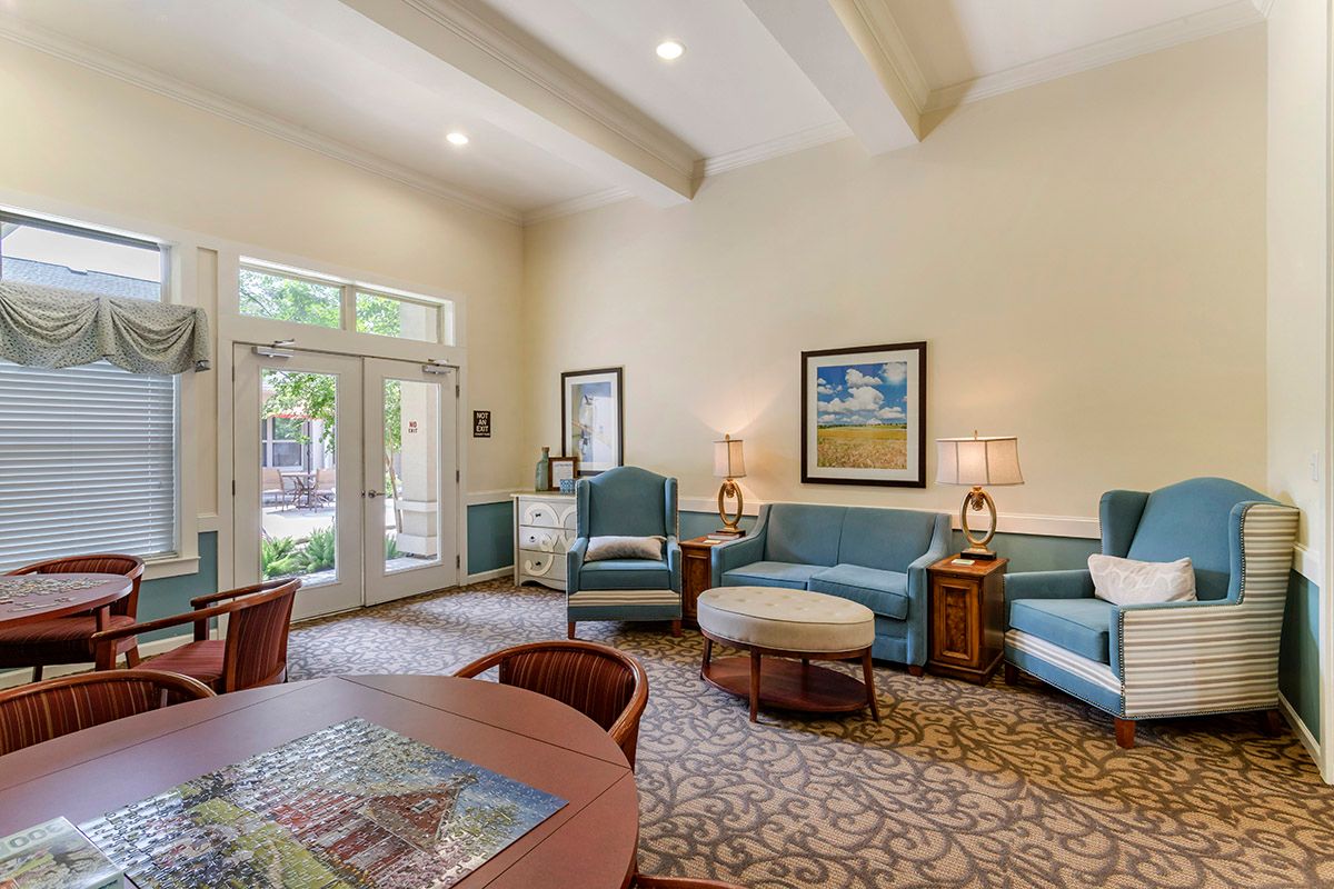 A cozy living room with comfortable seating, artwork on the walls, and a warm ambiance.