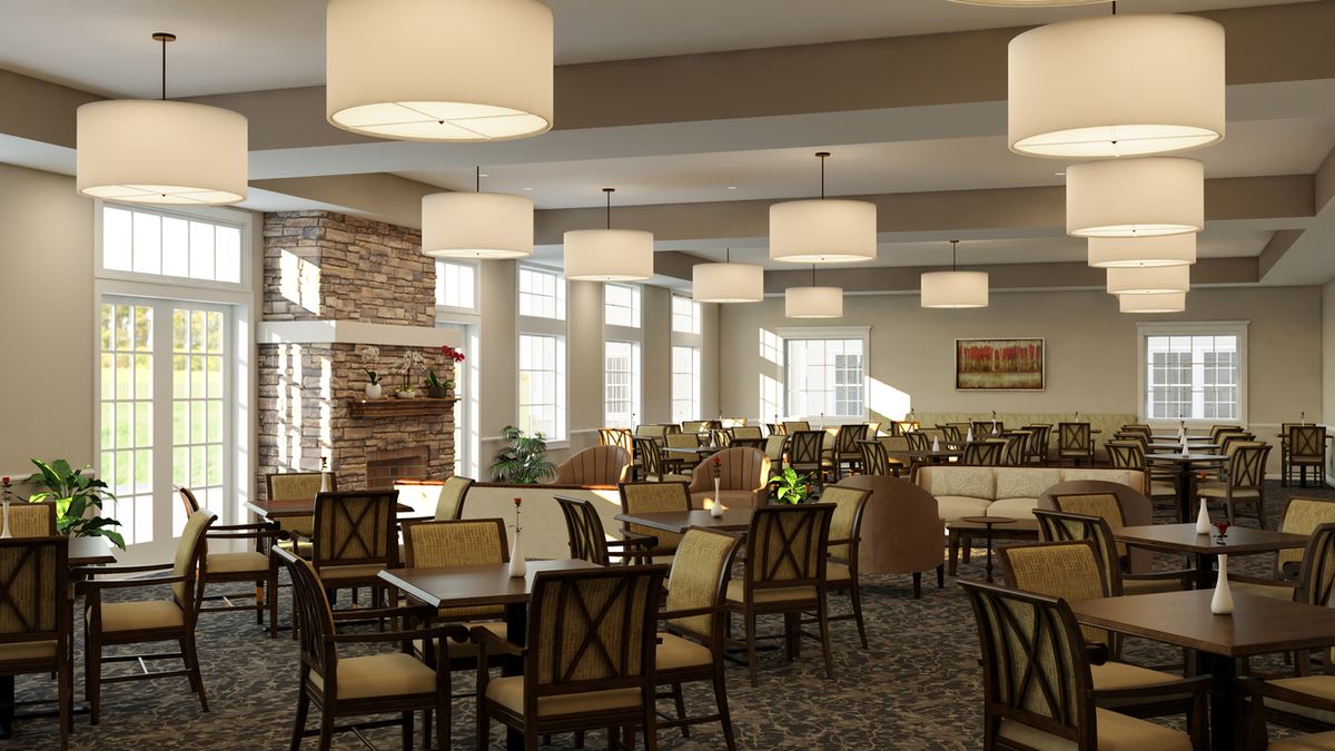 A spacious and elegantly designed dining room with multiple tables and chairs, featuring modern lighting fixtures and large windows allowing natural light to enter.