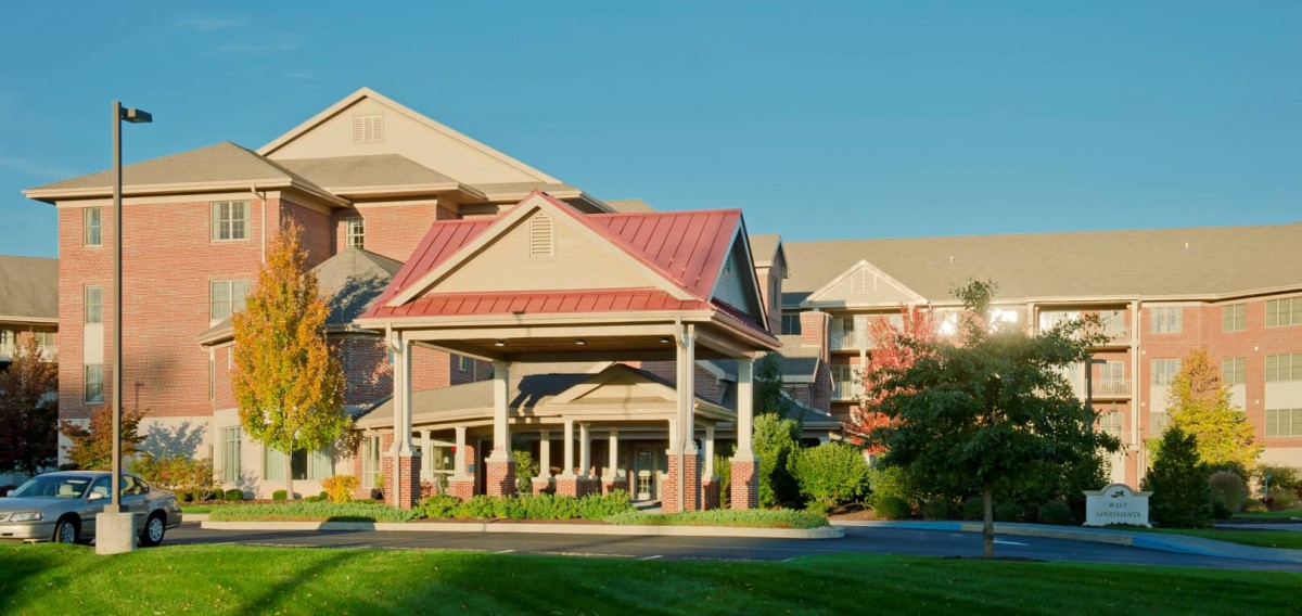 A residential building with a prominent entrance and landscaped surroundings.