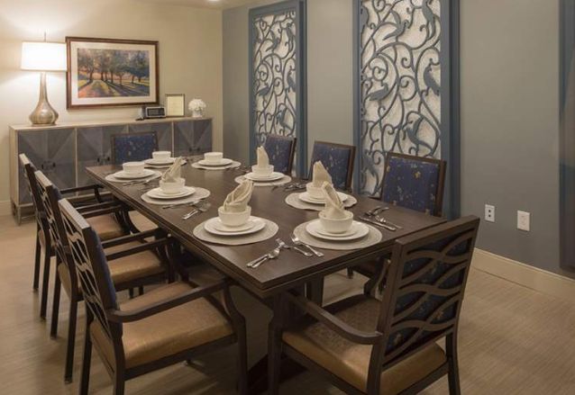A neatly set dining table with elegant decor and stylish chairs.