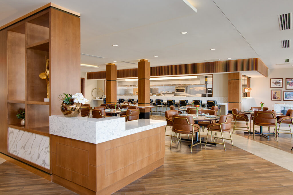 A contemporary dining area with wooden furniture and modern decor.
