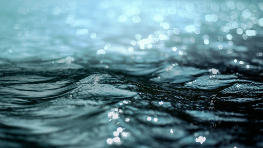 A close-up view of shimmering water waves, capturing the tranquility and beauty of nature.