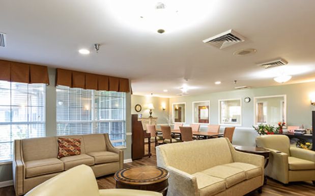 A cozy living room with comfortable sofas and warm lighting.