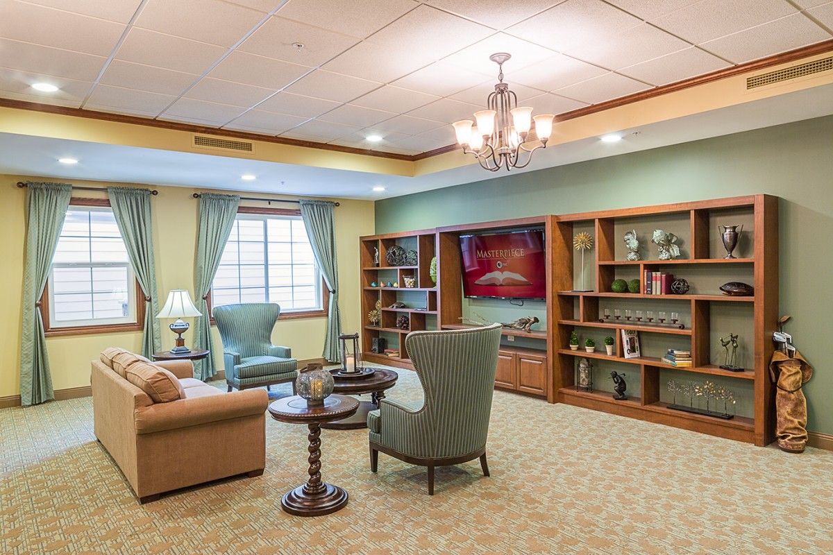A cozy living room with comfortable seating and bookshelves.
