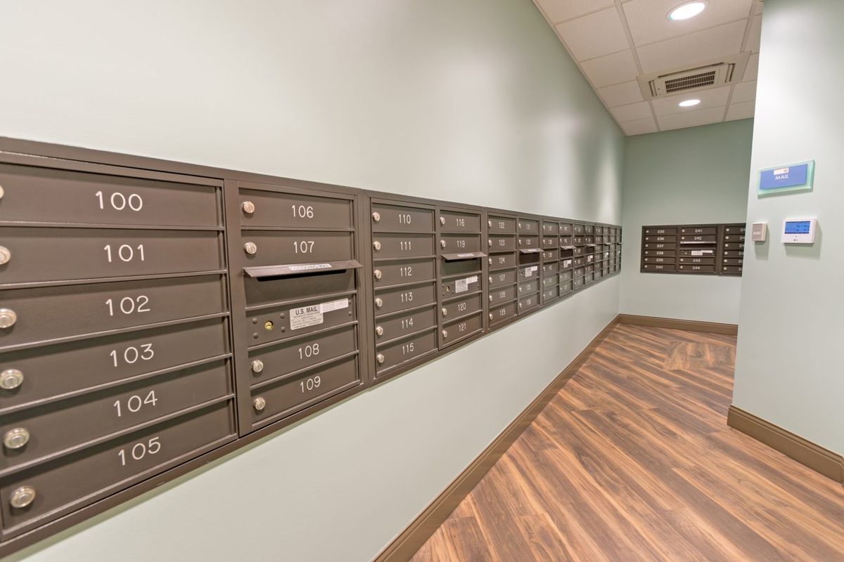 A corridor lined with mailboxes in an apartment complex.