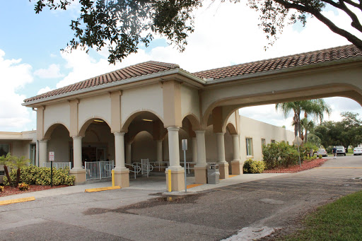 A stylish building featuring a welcoming entrance with arches and columns.